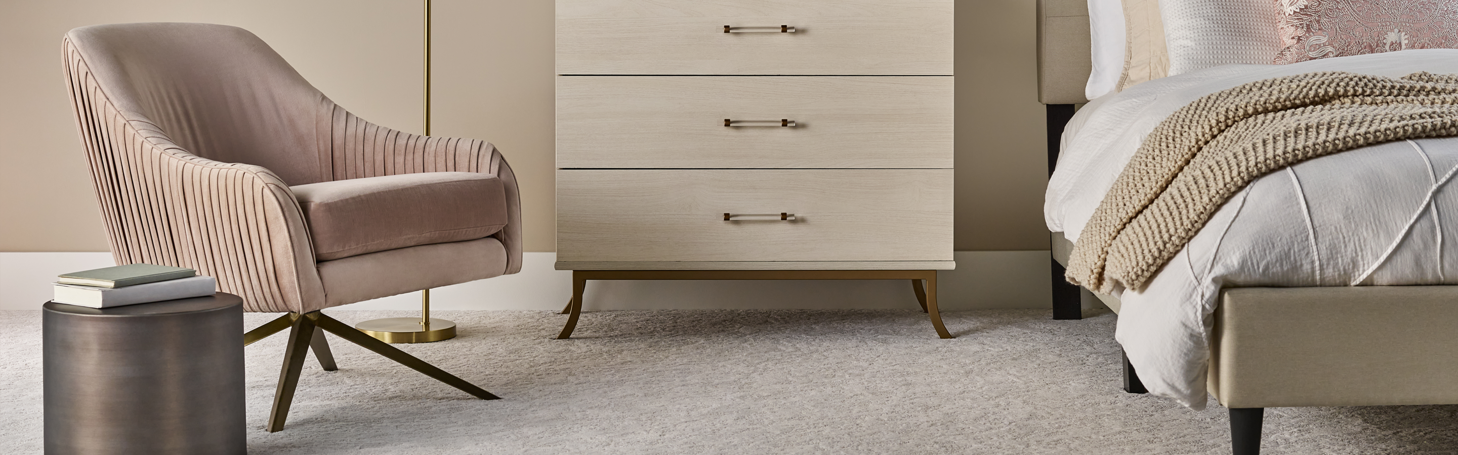 Pale beige bedroom carpet with tan walls and chair 
