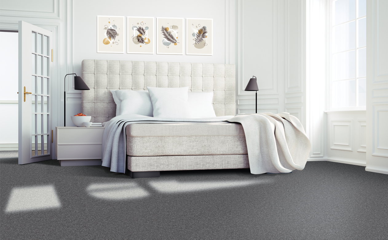 Grey carpet in master bedroom with upholstered headboard 